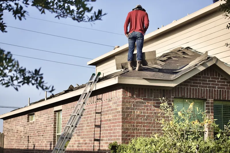 Professional roofer working on a residential roof in Castle Oaks